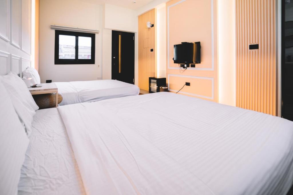 Postel nebo postele na pokoji v ubytování Xiaoliuqiu Ayana B&B