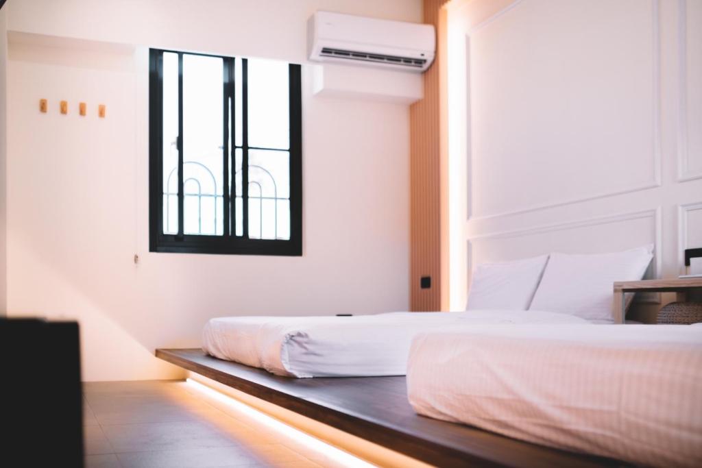 Postel nebo postele na pokoji v ubytování Xiaoliuqiu Ayana B&B