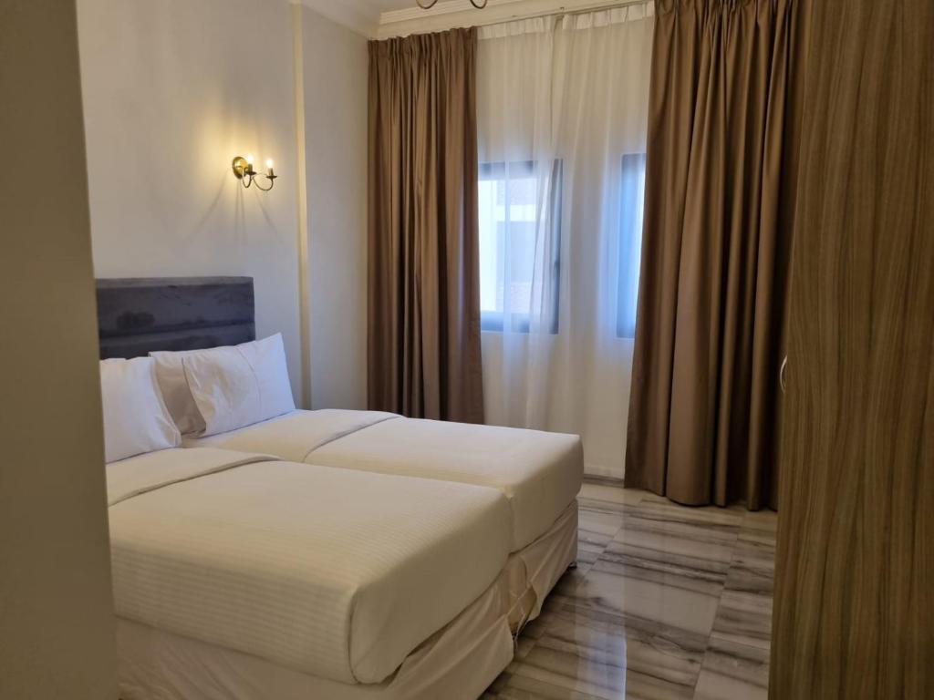 a hotel room with a bed and a window at Grand Stay Holiday Homes Al Jaddaf in Dubai