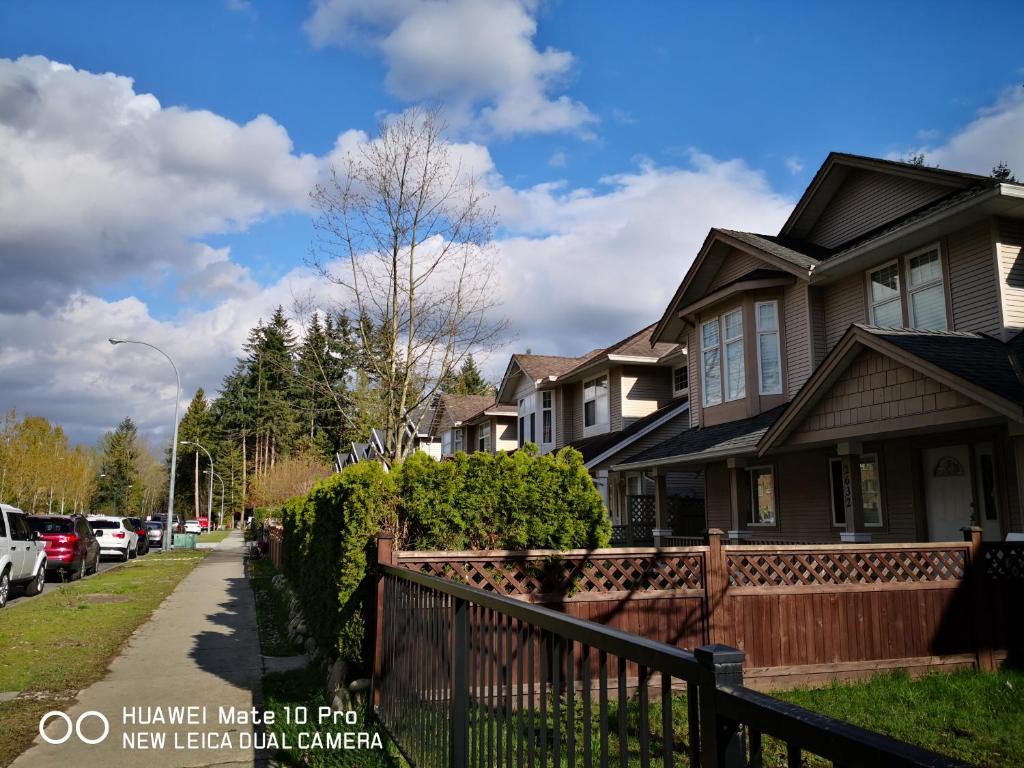 a row of houses on a residential street at Coquitlam center, 2 bedroom suite, walking to skytrain in Port Coquitlam