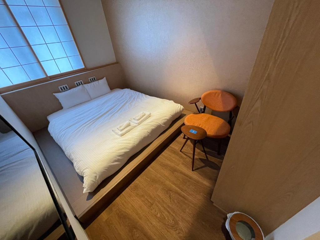 Postel nebo postele na pokoji v ubytování 利々 京都 lili hotel kyoto