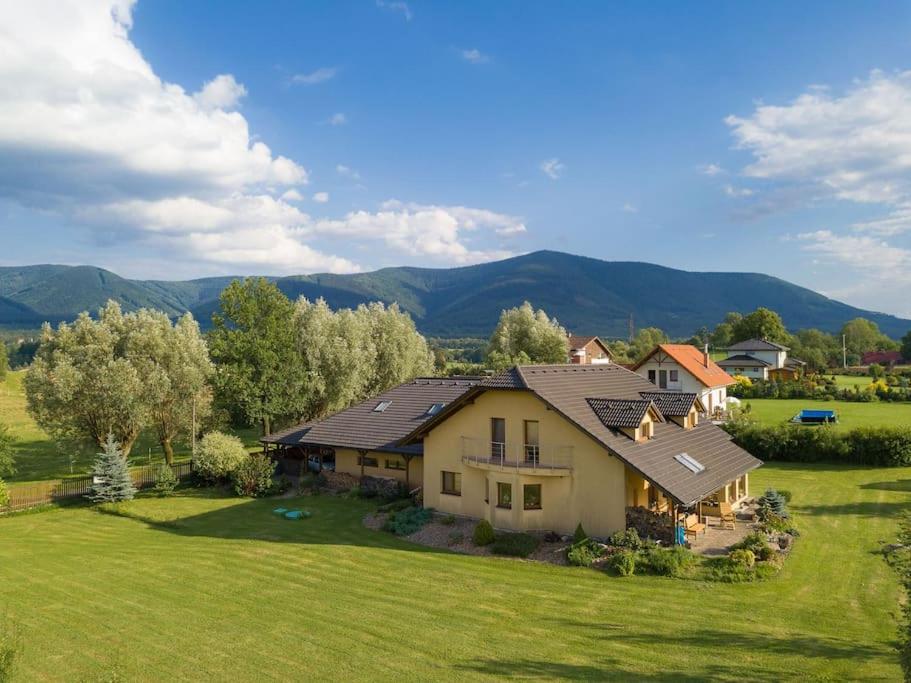 an aerial view of a house with mountains in the background at Na Helštýně in Frenštát pod Radhoštěm