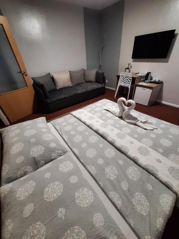 salon z 2 łóżkami i kanapą w obiekcie Hotel Boršičanka w Hawierzowie