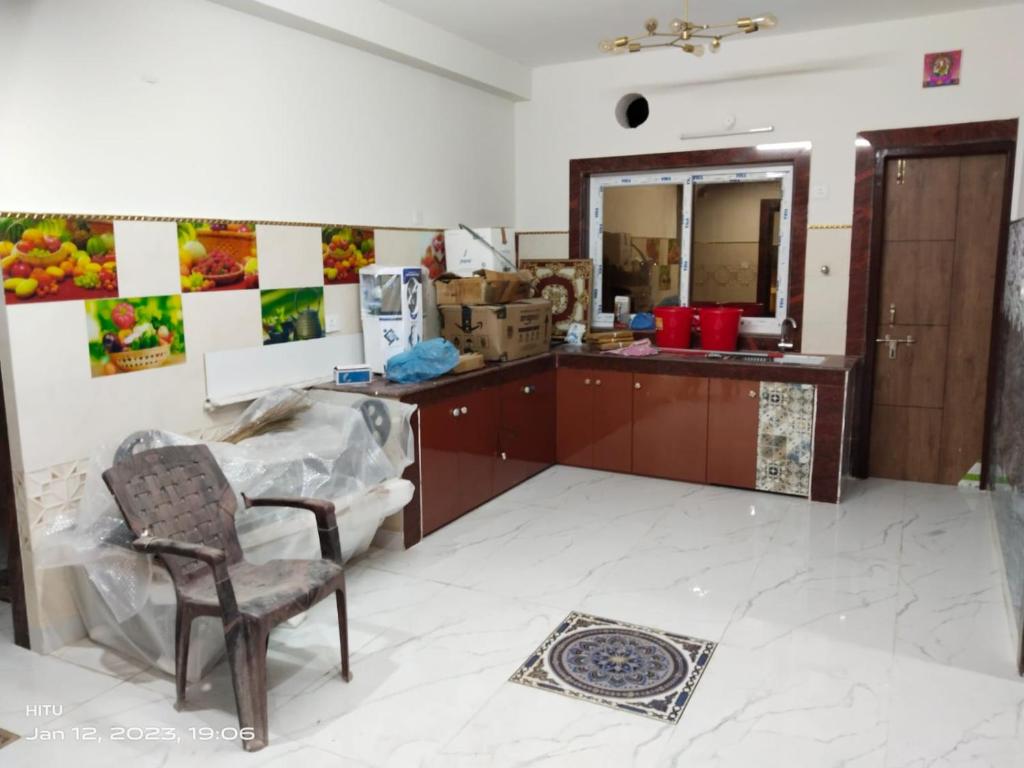 a kitchen with a table and a chair and a mirror at MEGA HOME in Bhubaneshwar