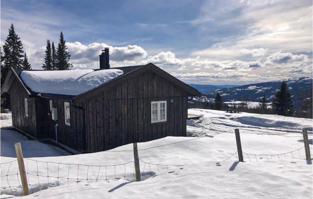 a small wooden cabin with snow on the roof at Nice Home In Etnedal With 3 Bedrooms in Etnedal