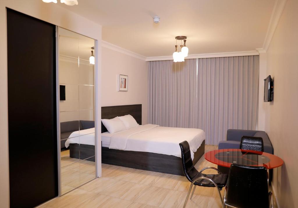ein Hotelzimmer mit einem Bett und einem Tisch in der Unterkunft Abu Alsoud Hotel in Amman