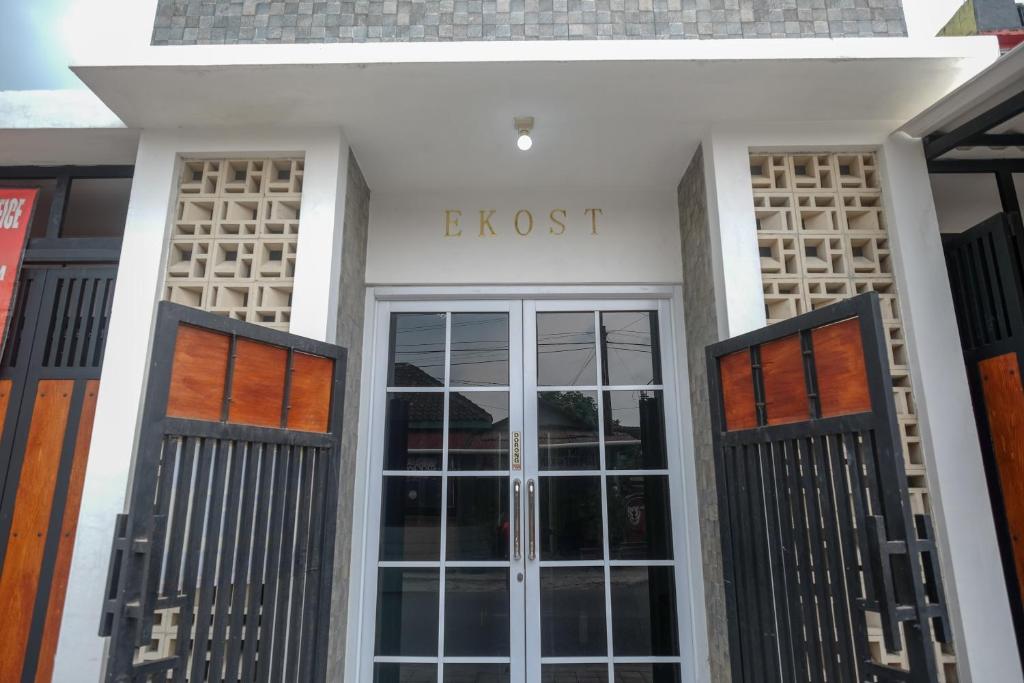 a front door of an office building with the wordboss at KoolKost Syariah near Luwes Gentan Park (Minimum Stay 30 Nights) in Sukoharjo