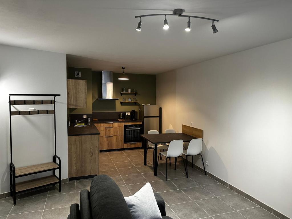 a living room and kitchen with a table and chairs at Le troubadour in La Roche-sur-Foron