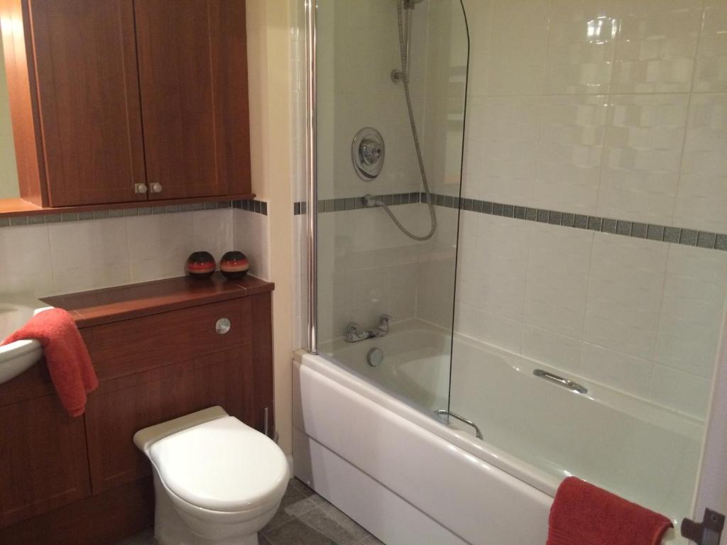 a bathroom with a shower and a toilet and a sink at AB11 Apartments - Portland Street in Aberdeen