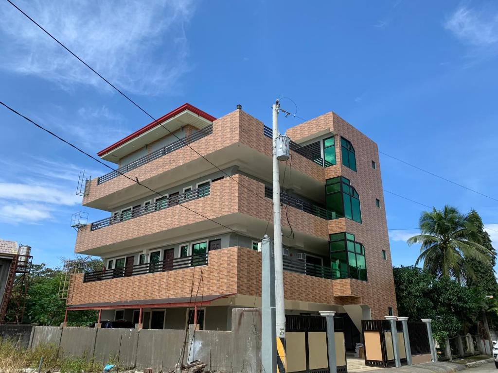 a tall brick building with a blue sky in the background at Suncrest Inn in Butuan