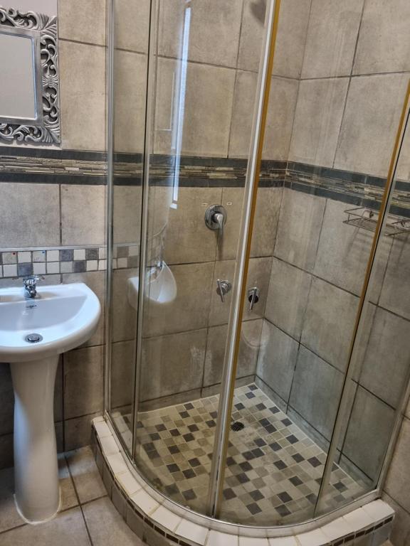y baño con ducha y lavamanos. en Gorgeous Gecko Guesthouse, en Modimolle