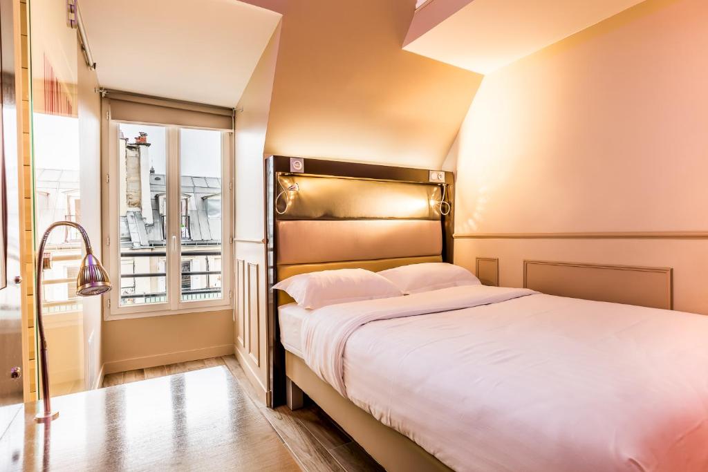 a bedroom with a large bed and a window at District Republique in Paris