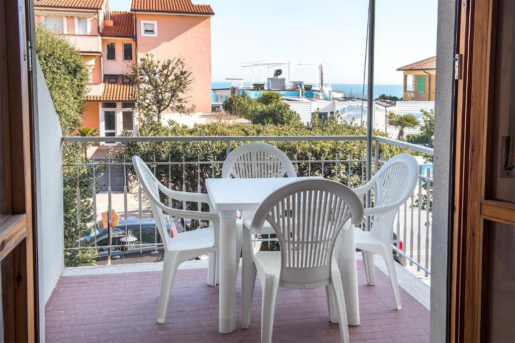 a white table and chairs on a balcony at M033 - Marcelli, trilocale in centro fronte mare in Marcelli