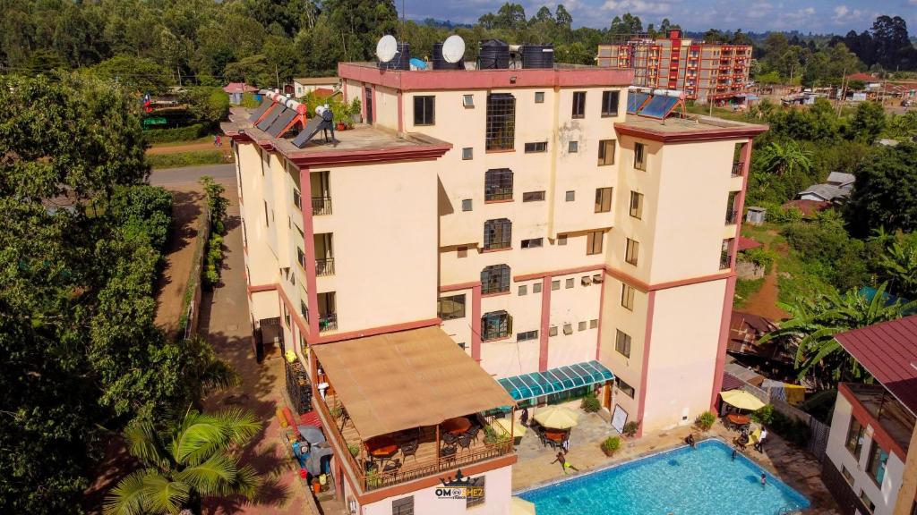 an overhead view of a building with a swimming pool at Omega Gardens Hotel in Karatina