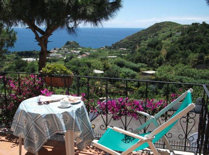 a table and chairs on a balcony with a view of the ocean at Hotel Bellavista Ischia in Ischia