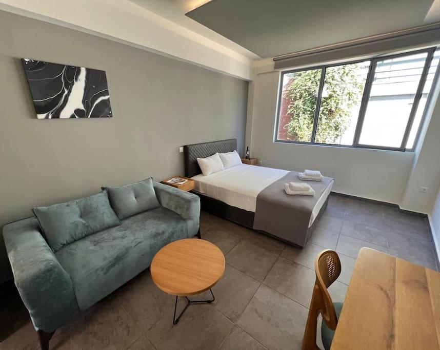 a room with a couch and a bed and a table at Acropolis View Apartment Athens Downtown in Athens