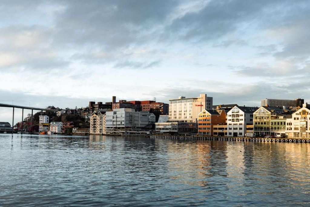a city with buildings and a bridge over the water at Scandic Kristiansund in Kristiansund