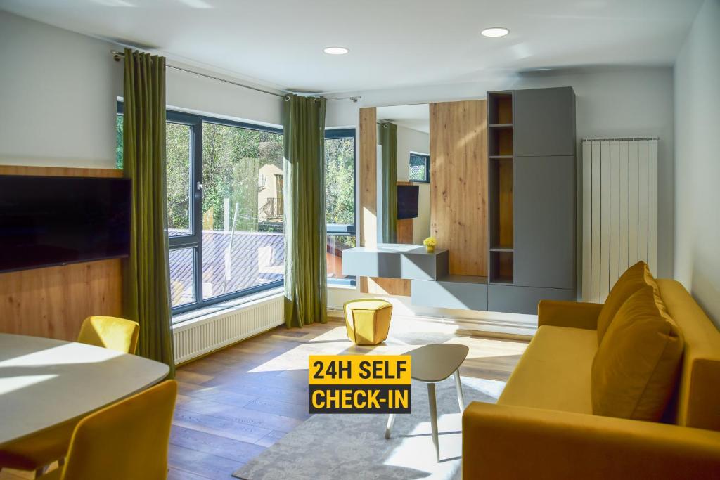 a living room with a couch and a table at Royal Maison Apartments in Cluj-Napoca