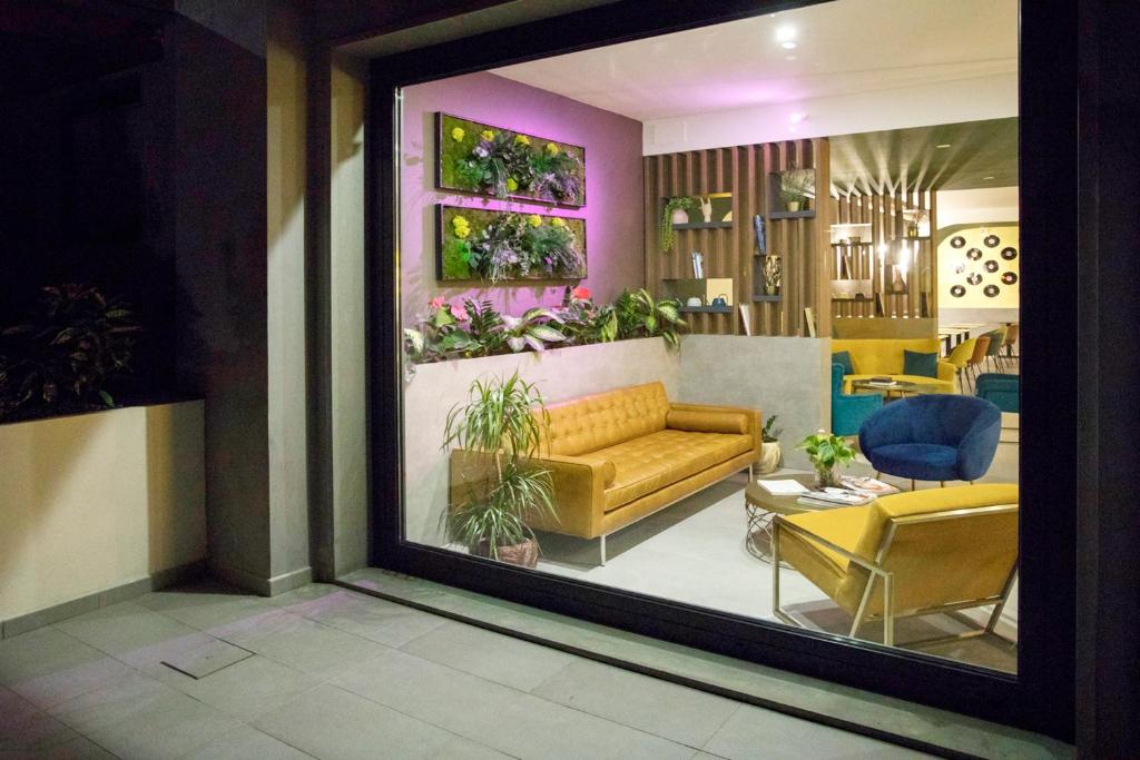 a view of a living room with a couch and chairs at Moody smart & comfy Hotel in Terranuova Bracciolini