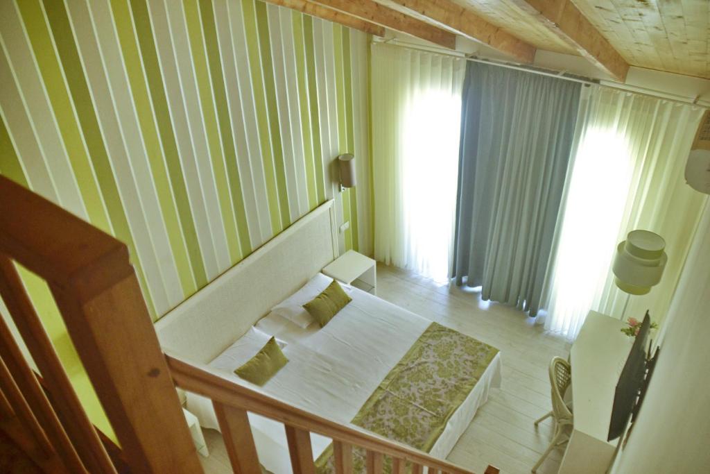 Postel nebo postele na pokoji v ubytování Ouril Hotel Julia