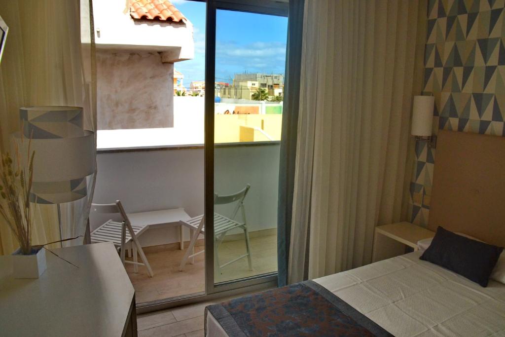 Postel nebo postele na pokoji v ubytování Ouril Hotel Julia