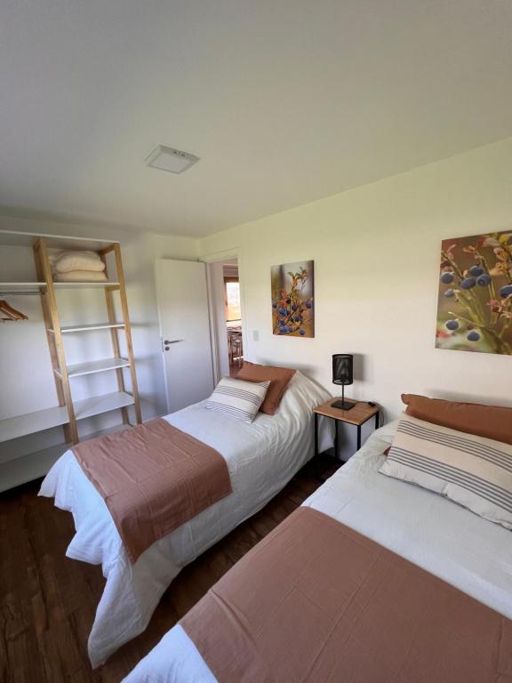 a bedroom with two beds and a ladder at Cabañas del lago in El Calafate