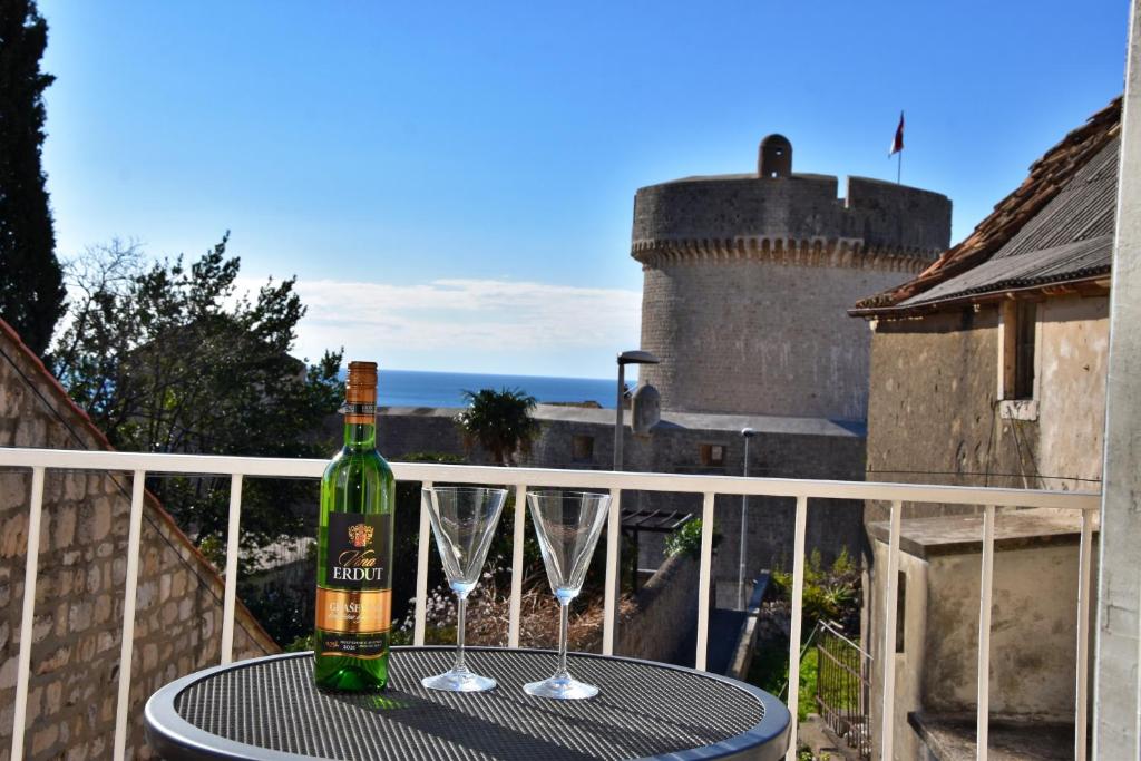 a bottle of wine sitting on a table on a balcony at Apartments Aurelia in Dubrovnik