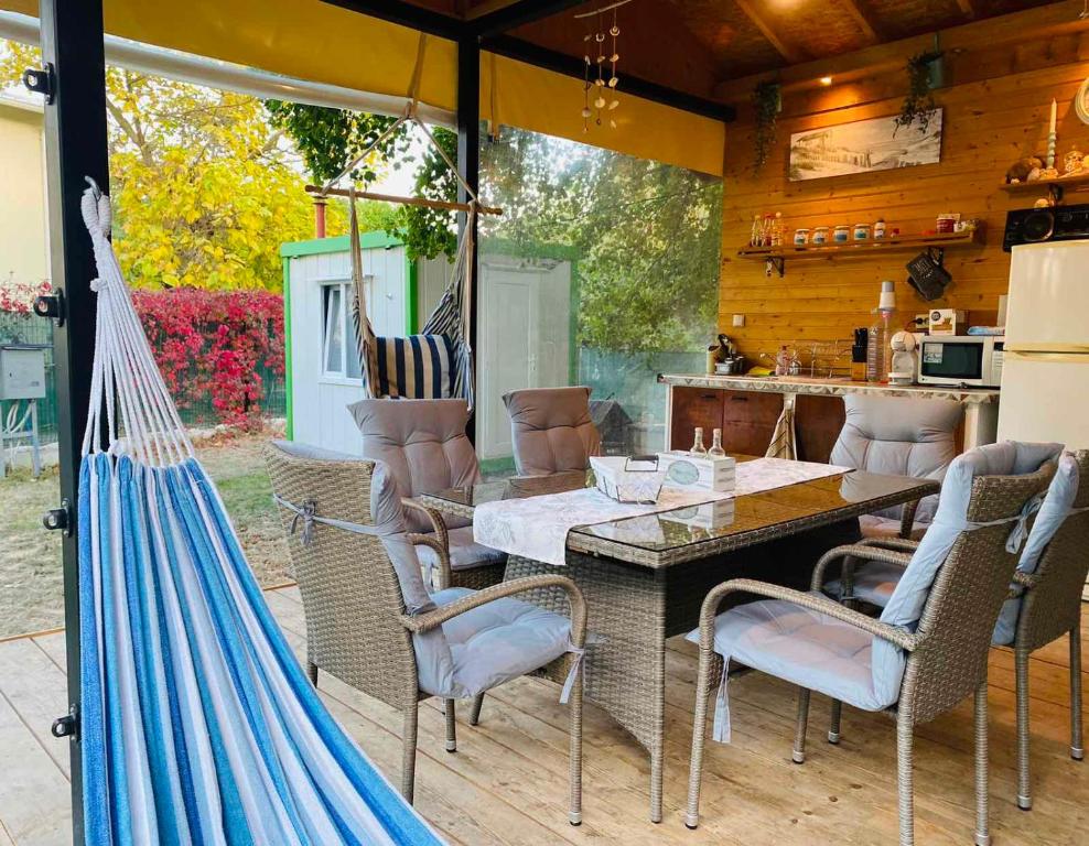 a patio with a table and chairs and a kitchen at Каравана Лили in Varna City