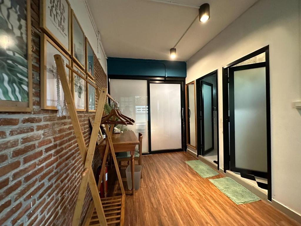 a hallway with a brick wall and a staircase at T-House BKK 2Floors near BTS with swimming pool and free Wifi in Klong Toi