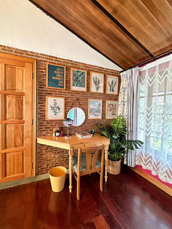 a desk in a room with a brick wall at T-House BKK 2Floors near BTS with swimming pool and free Wifi in Klong Toi