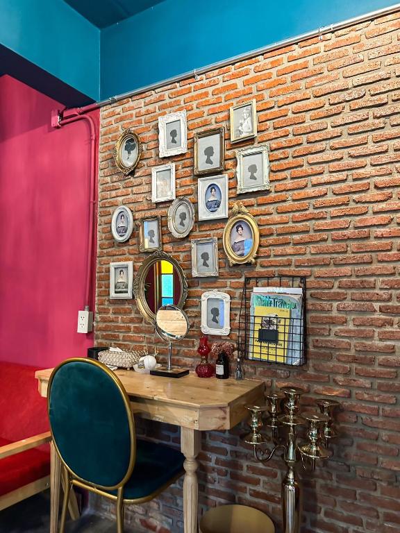 a brick wall with a table and a mirror at T-House BKK 2Floors near BTS with swimming pool and free Wifi in Klong Toi