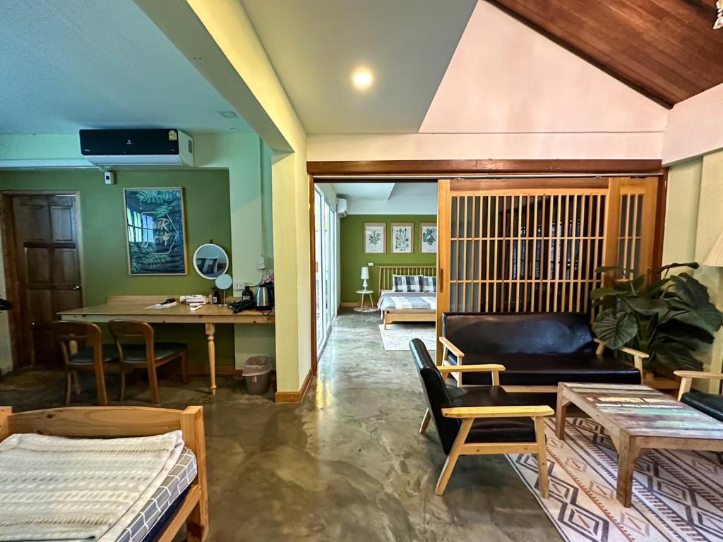 a living room with a couch and a table at T-House BKK 2Floors near BTS with swimming pool and free Wifi in Klong Toi