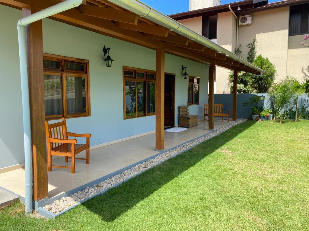 a house with a patio and a grass yard at Bella Pousada in Pomerode