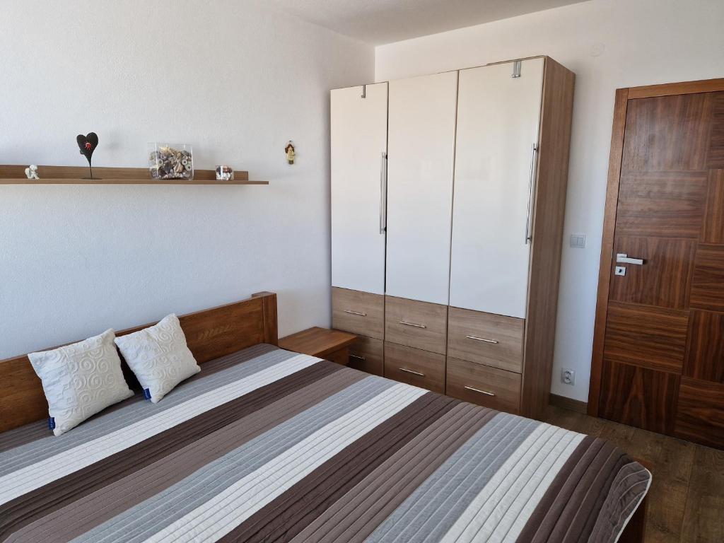 a bedroom with a bed and a large cabinet at Apartmán Rubicon in Poprad