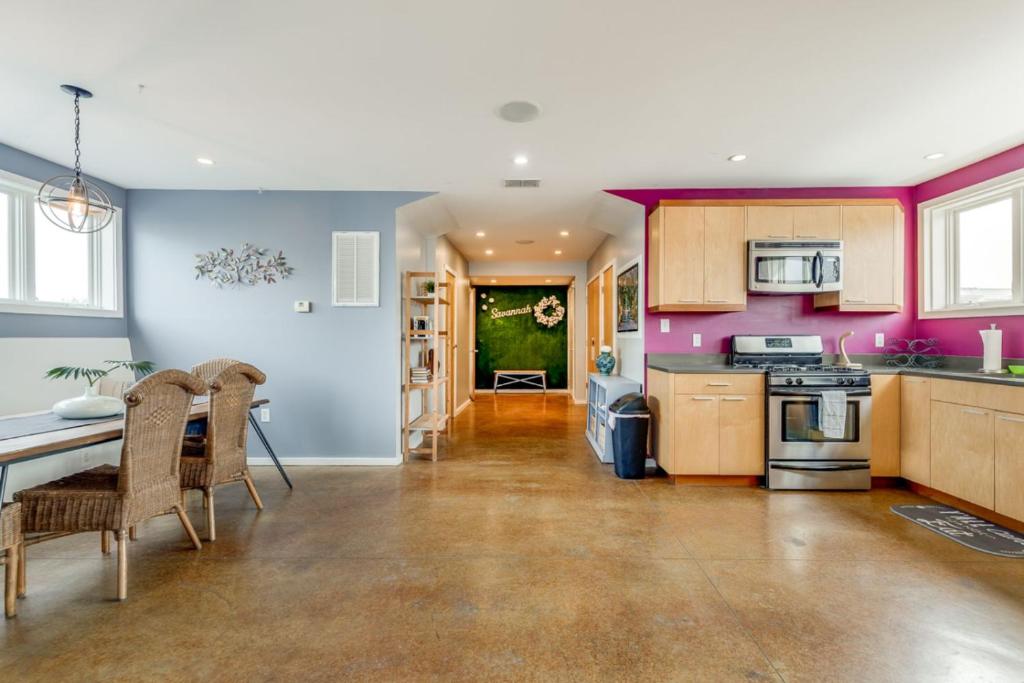 a kitchen with purple walls and a table and chairs at Walk Score 90!!-Historic Downtown District-2 Blocks to Famous Forsyth Park- Huge Private Patio-Private Parking in Savannah