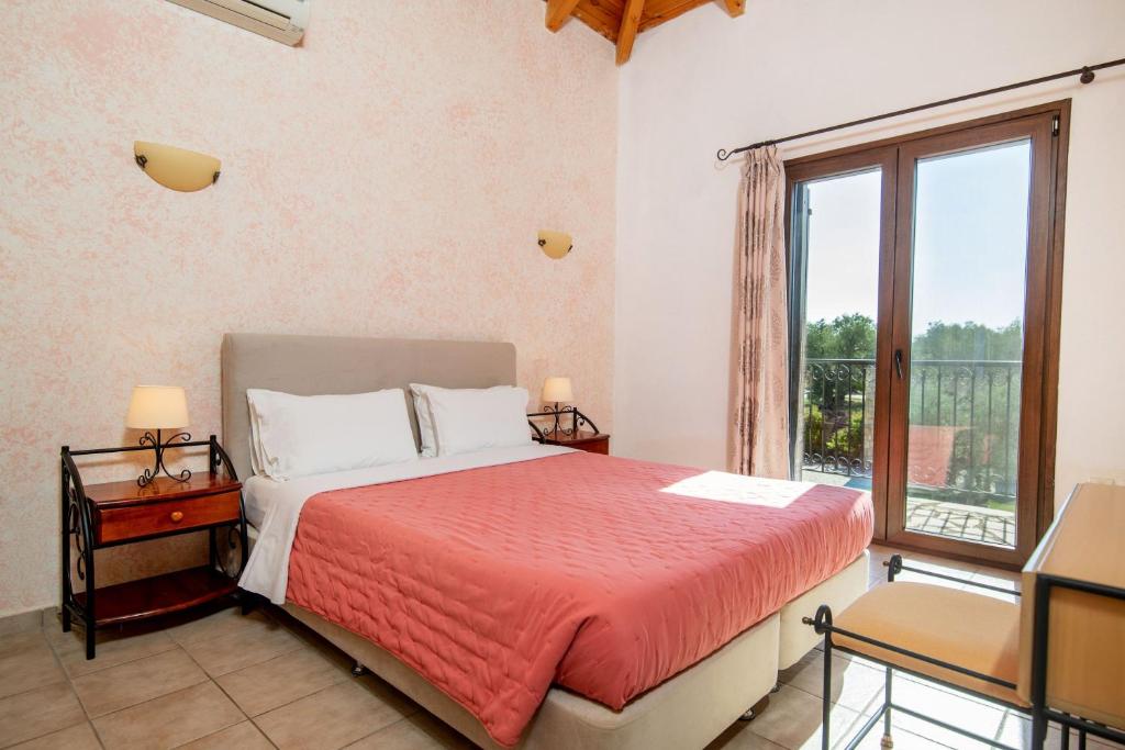 A bed or beds in a room at Olive Tree Villas