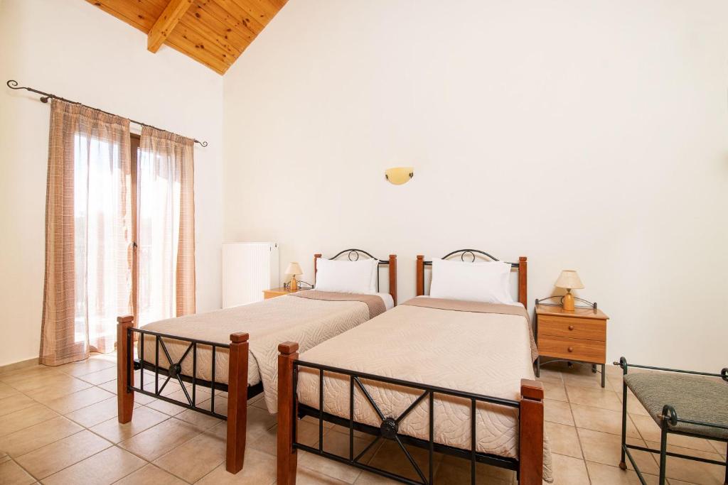A bed or beds in a room at Olive Tree Villas