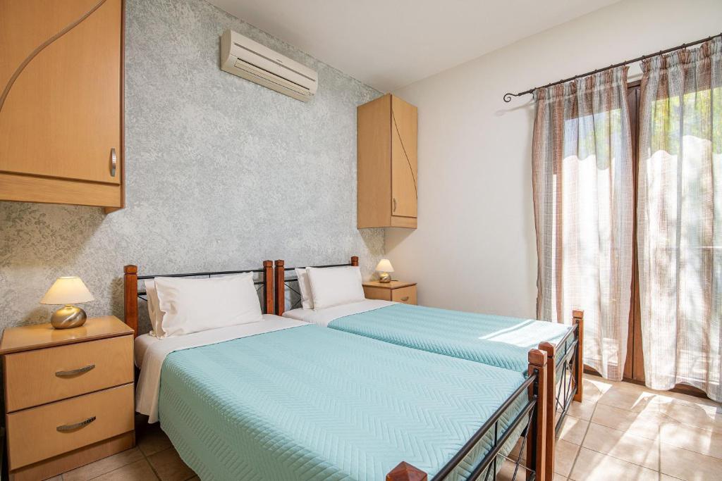 A bed or beds in a room at Olive Tree Villas