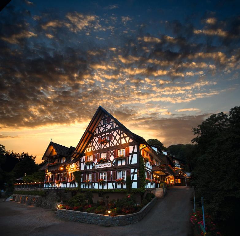 a large building with lights on it at sunset at Rebstock Waldulm in Kappelrodeck