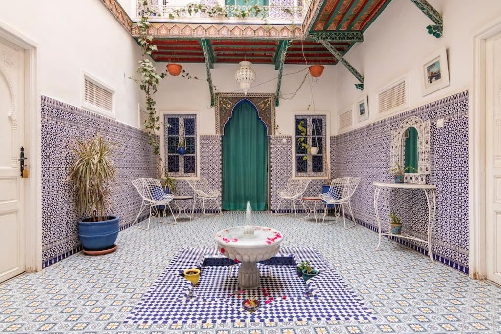 a room with a green door and a sink in it at Riad Hôtel Essaouira in Marrakech