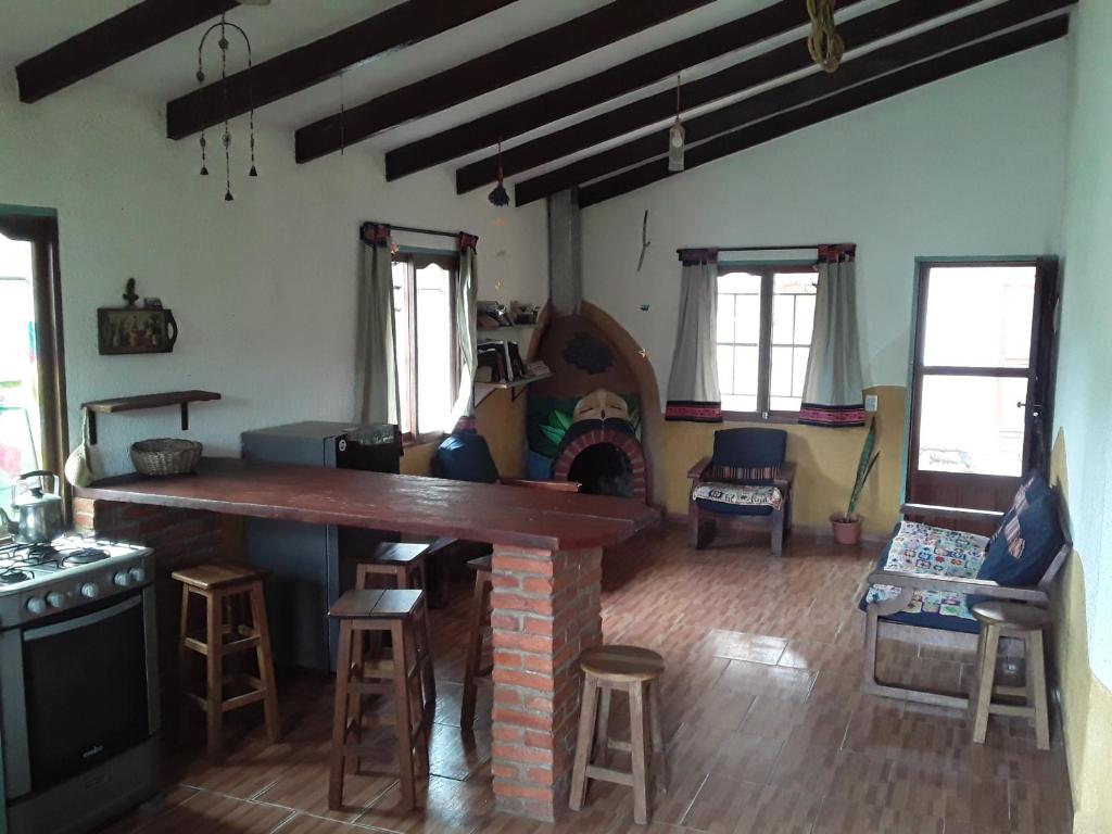 a living room with a stone counter and a fireplace at Casa Amaranta in Samaipata