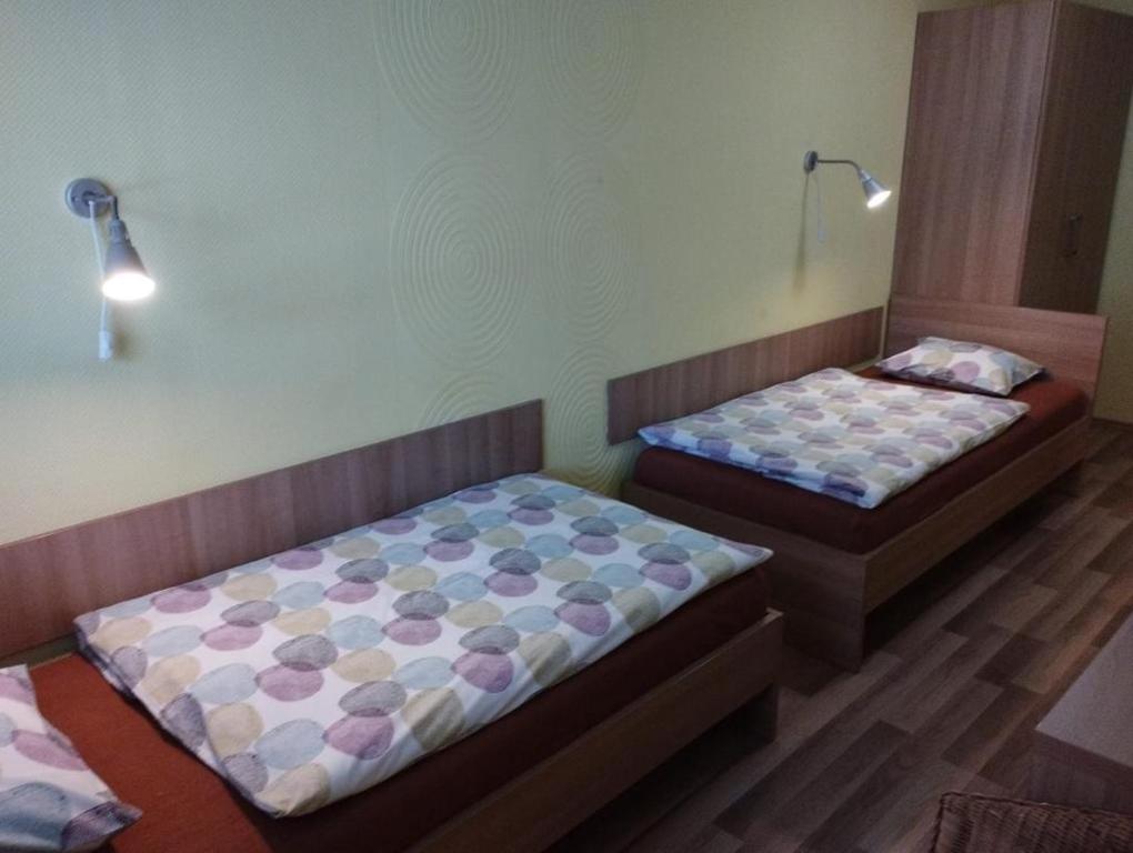 two beds in a room with two at GAS Truck centrum in Holíč
