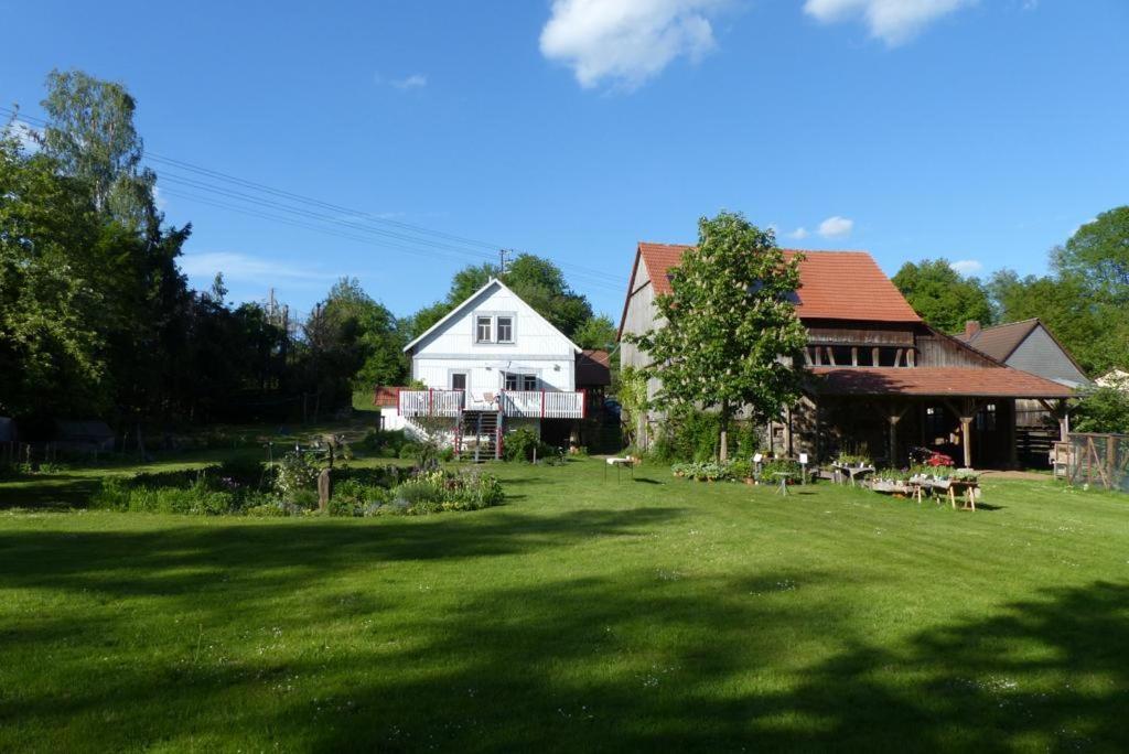 a white house with a yard and a house at Schlaf mal im Denkmal in Birstein