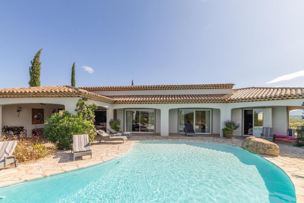 une piscine devant une maison dans l'établissement Le Mas de Heron, à Vidauban