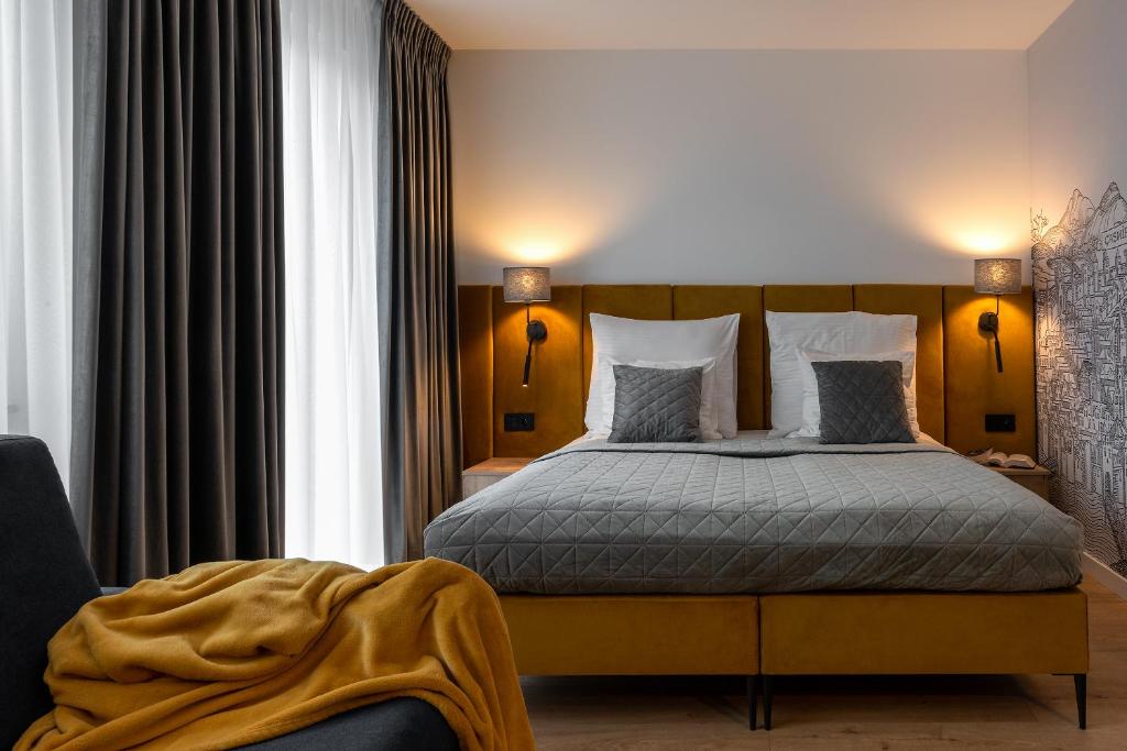 a bedroom with a large bed with two pillows at InPoint Central Apartments Old Town&Kazimierz - Free Parking in Krakow