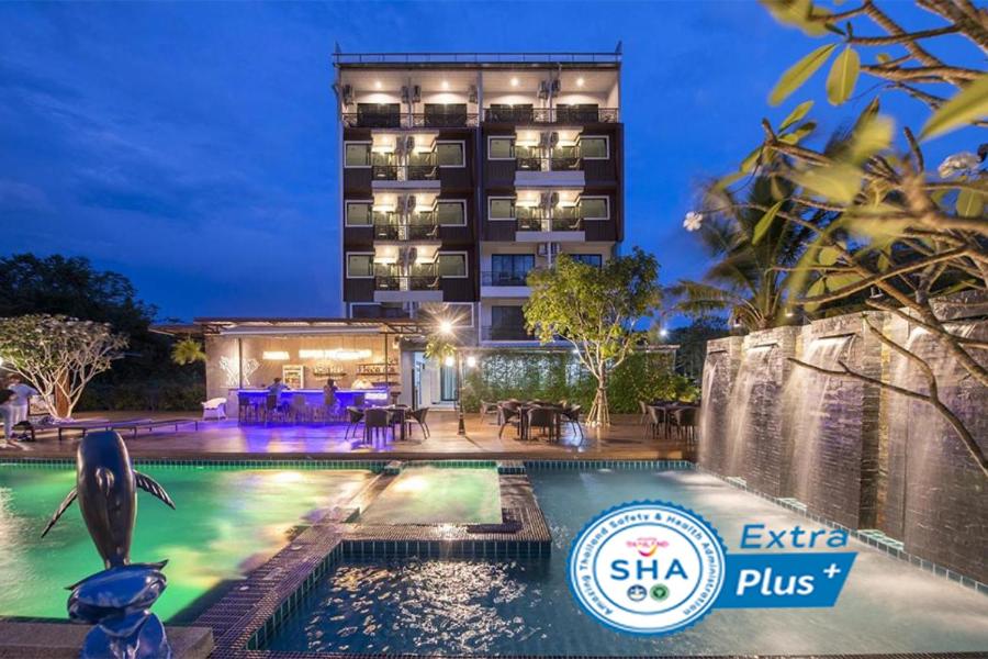 a hotel with a swimming pool in front of a building at River Front Krabi Hotel in Krabi