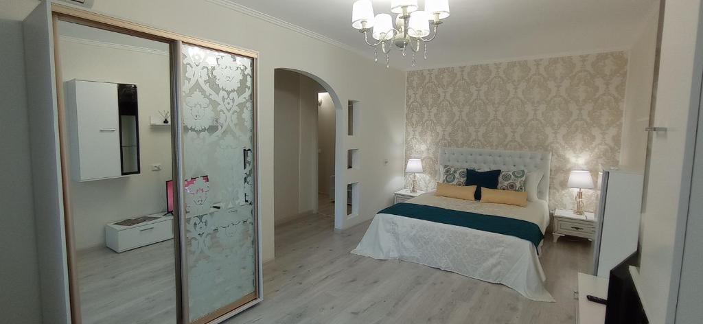 a bedroom with a bed and a large mirror at Park Apartments in Dnipro