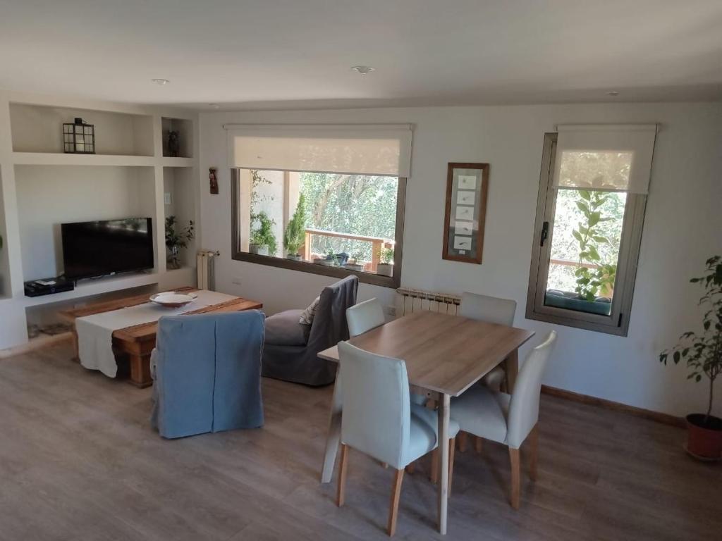 a living room with a table and a couch at Casa de Huéspedes Villa Pehuenia in Villa Pehuenia