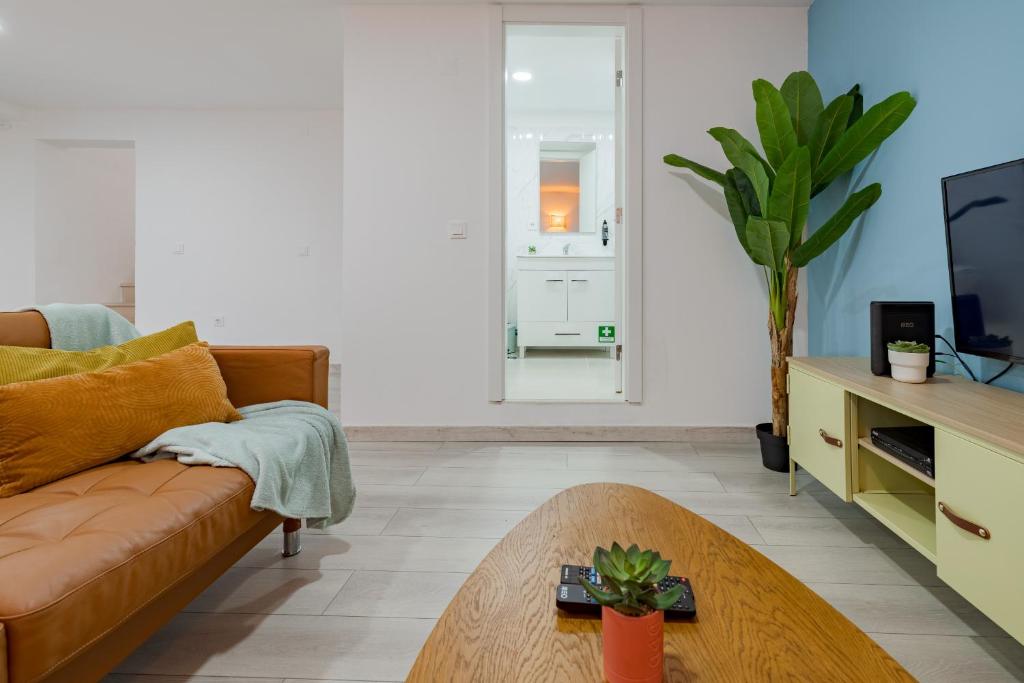a living room with a couch and a table at Good Vibes Apartment in Setúbal