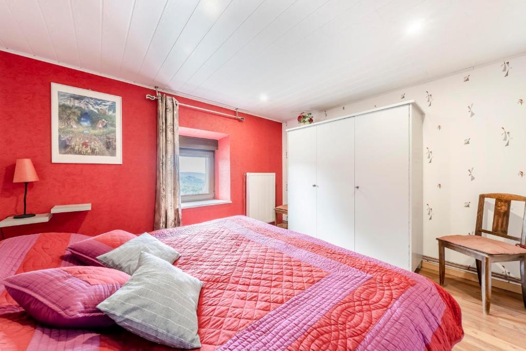 a bedroom with red walls and a large bed at Maison de 3 chambres avec jardin clos et wifi a Dabo in Dabo